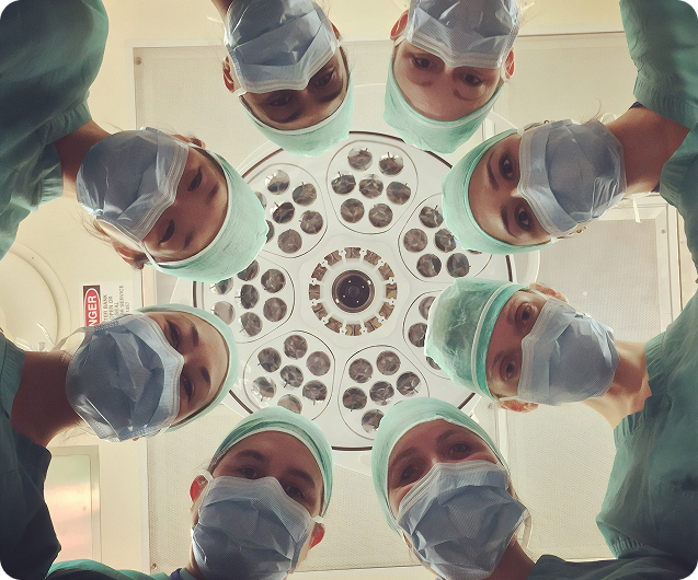 Doctors standing around a surgery patient